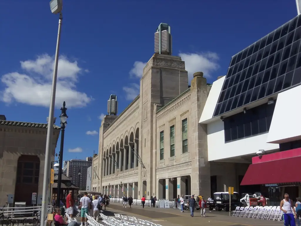 The arched stone facade and corner towers of Boardwalk Hall on the Boardwalk under a blue sky