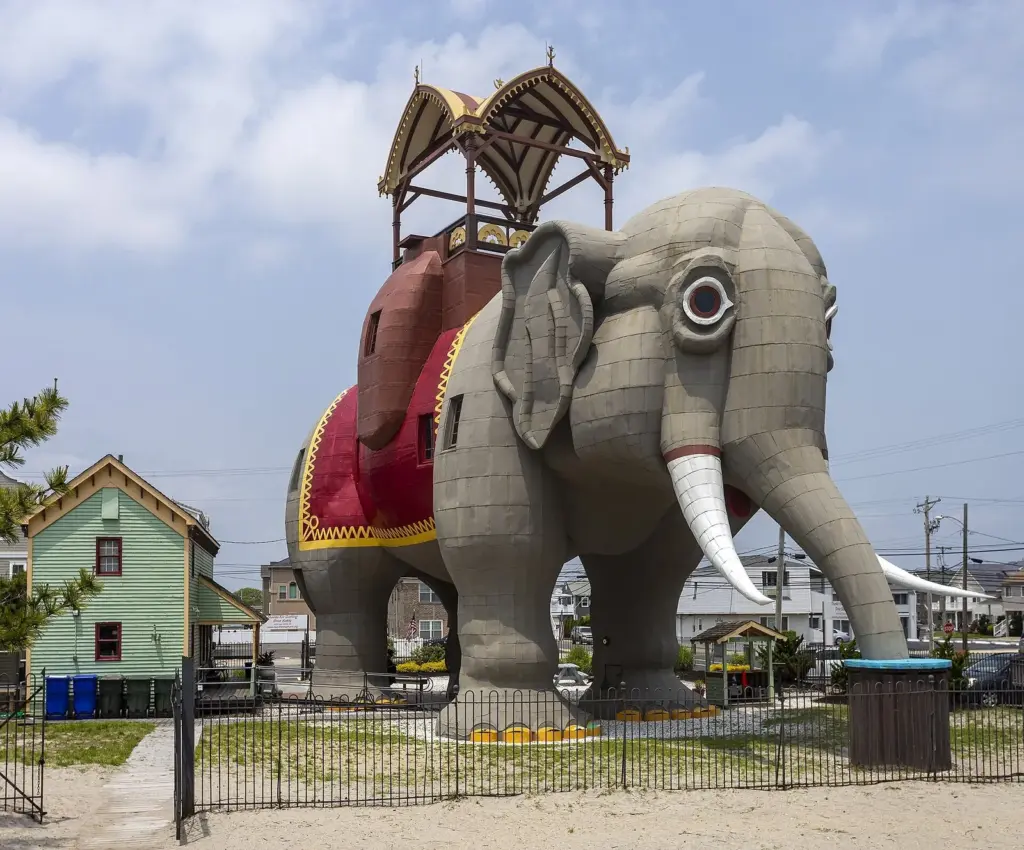 Lucy the Elephant, a six-story wooden elephant with a canopied howdah on her back, standing beside a house in Margate