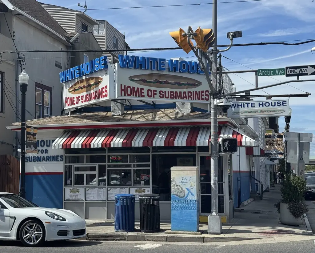 The White House Sub Shop's corner building with its red and white awning and 'Home of Submarines' signs on Arctic Avenue