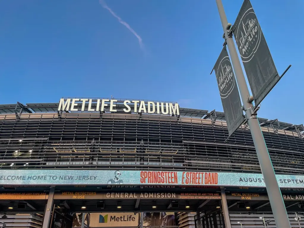 The stadium's name in large letters above an entrance, over a banner welcoming Bruce Springsteen and the E Street Band home to New Jersey