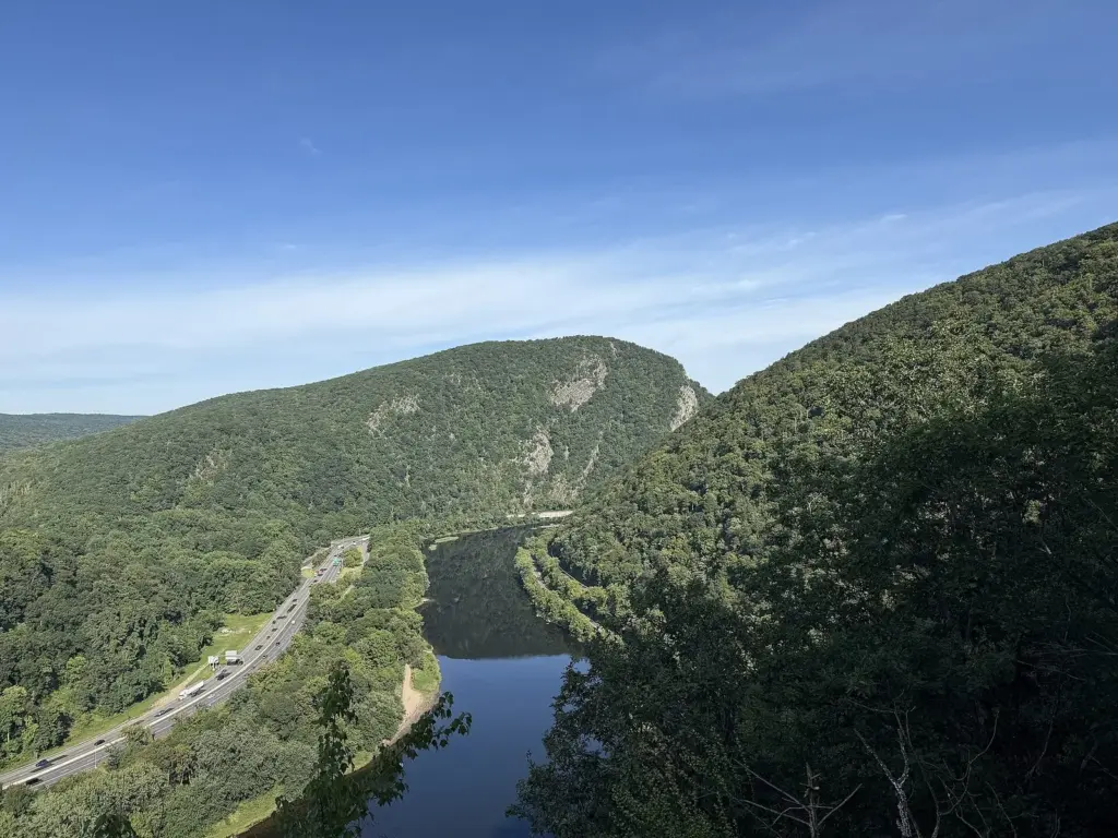 Mount Tammany's rocky, forested face rising above the Delaware River and Interstate 80, seen across the Gap from a lookout in Pennsylvania